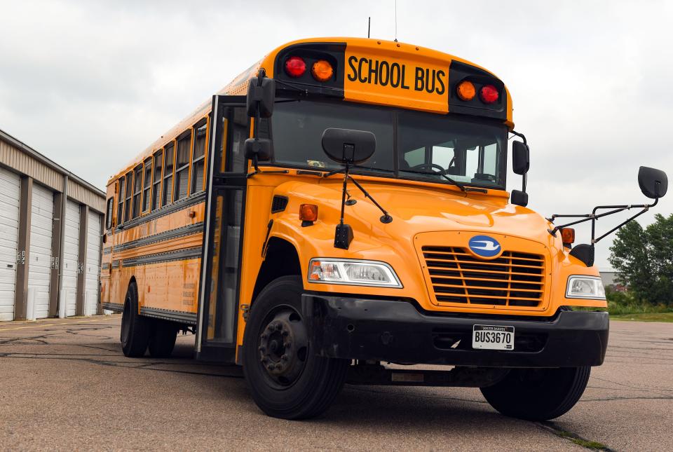A bus sits parked outside the School Bus Inc. building Friday in Sioux Falls, S.D.