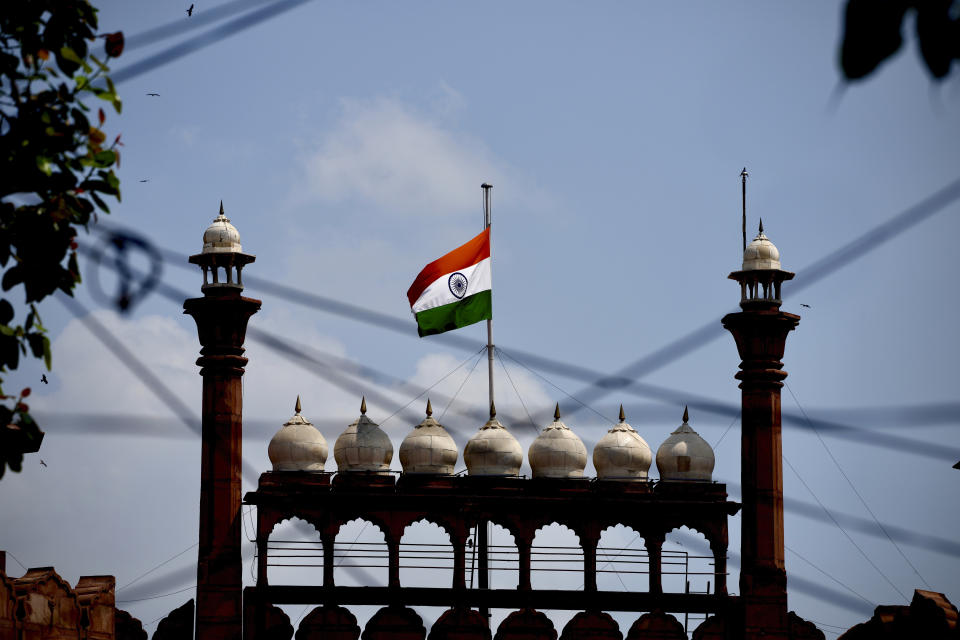 The Indian flag flies at half-mast at the historic Red Fort following Thursday’s death of Britain's Queen Elizabeth II in New Delhi, India, Sunday, Sept.11, 2022. (AP Photo/Manish Swarup)