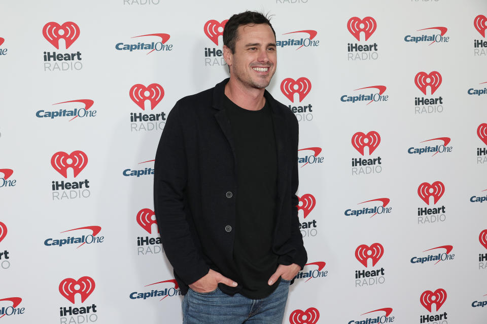 Ben Higgins wears a black shirt and jacket with jeans