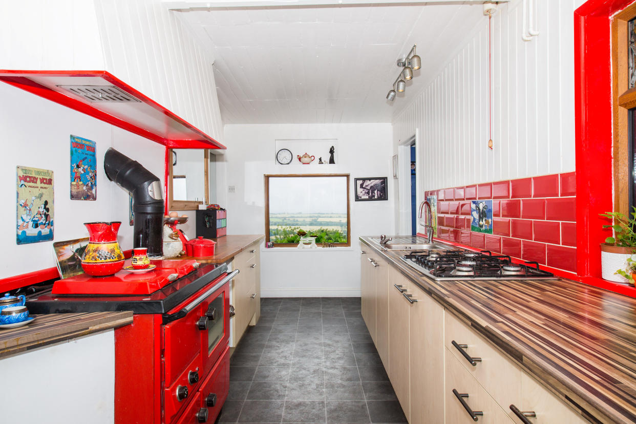 There’s a lovely kitchen, which comes complete with picture window and red range. (SWNS)