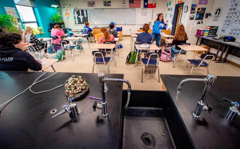 Mary Ervin passes out a quiz in her 10th grade chemistry class at Lipan High School Friday, March 24, 2023.