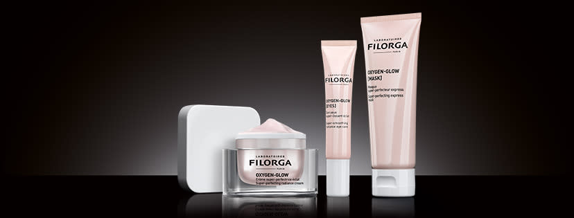 A small bottle and two tubes of Filorga products.