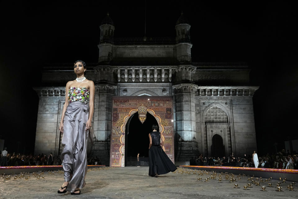 Models display creations for the Dior Pre-Fall 2023 collection at the Gateway of India landmark monument in Mumbai, India, Thursday, March 30, 2023. (AP Photo/Rafiq Maqbool)