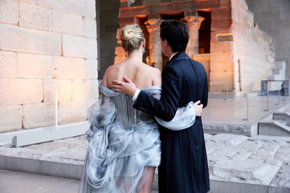 Lili Reinhart and Cole Sprouse look at art in the Metropolitan Museum during the 2018 Met Gala.