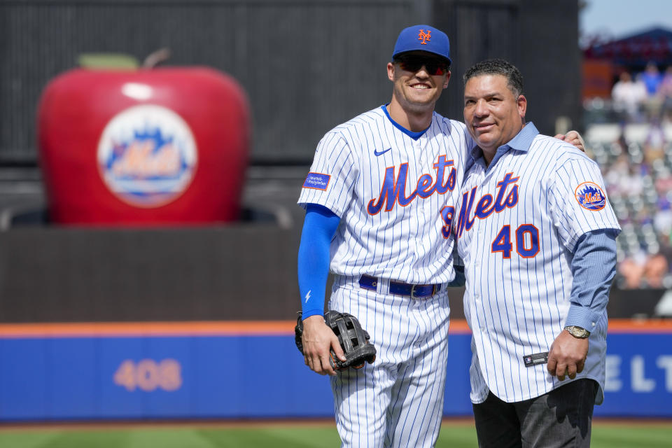 Former New York Mets pitcher Bartolo Colon (40) poses with Brandon Nimmo after delivering the ceremonial first pitch before the start of a baseball game between the New York Mets and the Cincinnati Reds, Sunday, Sept. 17, 2023, in New York. (AP Photo/Mary Altaffer)