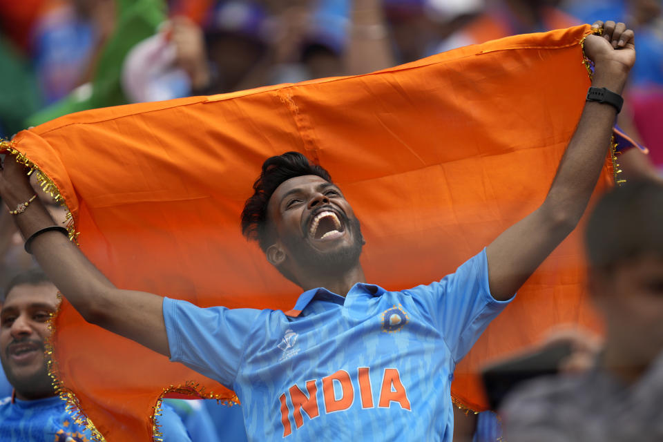 A fan cheers for the Indian cricket team before the start of ICC Men's Cricket World Cup match between India and Pakistan in Ahmedabad, India, Saturday, Oct. 14, 2023. (AP Photo/Rajanish Kakade)