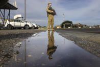 An Australian soldier stands on the tarmac at Honiara Airport, Solomon Islands, Tuesday, Nov. 30, 2021. New Zealand announced Wednesday, Dec. 1, 2021, that they will send up to 65 military and police personnel to the Solomon Islands over the coming days after rioting and looting broke out there last week.(Gary Ramage via AP)