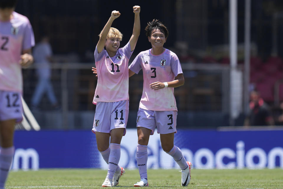 Japan's Mina Tanaka, center, celebrates with teammate Meek Minami, right, after scoring her side's second goal against Brazil during a women's friendly soccer match at Morumbi stadium in Sao Paulo, Brazil, Sunday, Dec. 3, 2023. (AP Photo/Andre Penner)