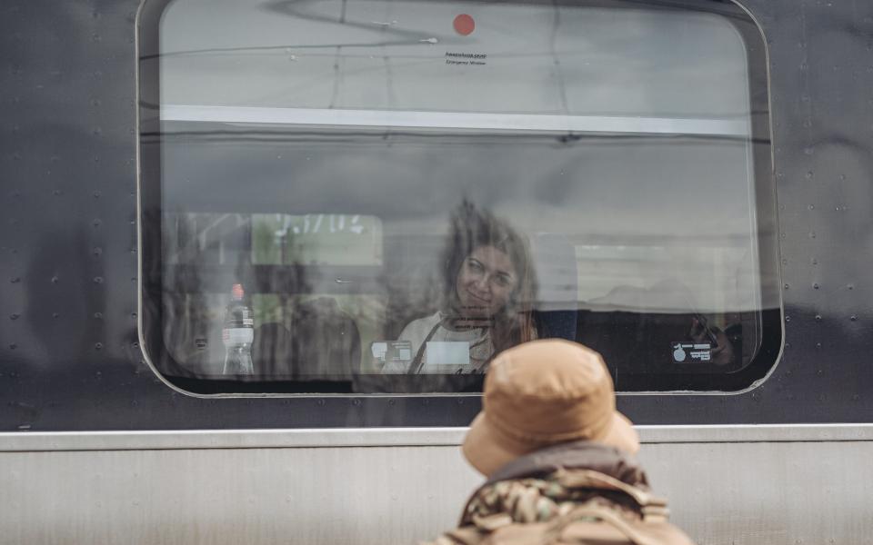 A Ukrainian soldier says goodbye to his relative as she takes a train to Odessa - Anadolu Agency/Anadolu