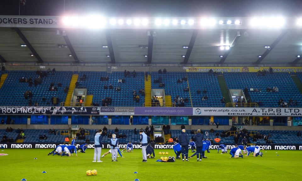 Millwall players warm up at The Den, which the club now hope to redevelop.