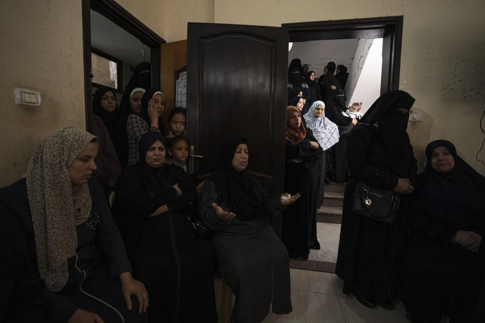 Relatives attend the funeral of Khalil Bahtini, the Islamic Jihad militant group's commander for the northern Gaza Strip, his wife and son, who were killed in an Israeli airstrike at their family home in Gaza City, Tuesday, May 9, 2023. Bahtini was among three senior Islamic Jihad commanders killed in targeted airstrikes early Tuesday. Palestinian health officials said at least 10 others were killed, including wives of two of the militants, several of their children and others nearby. (AP Photo/Fatima Shbair)