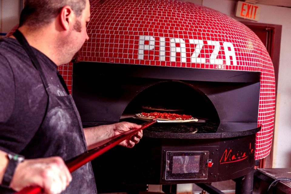 The cherry red Italian brick pizza oven will be a focal point of Piazza Pizza's new location slated to open in May.