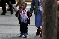 <p>A young boy carries an American flag as people gather at the National 911 Memorial and Museum during ceremonies marking the 16th anniversary of the September 11, 2001 attacks in New York, Sept. 11, 2017. (Photo: Brendan McDermid/Reuters) </p>