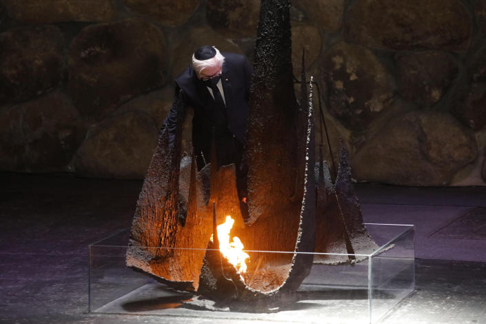 German President Frank-Walter Steinmeier rekindles the Eternal Flame in the Hall of Remembrance at the Yad Vashem Holocaust memorial in Jerusalem, Thursday, July 1, 2021. (AP Photo/Ariel Schalit)
