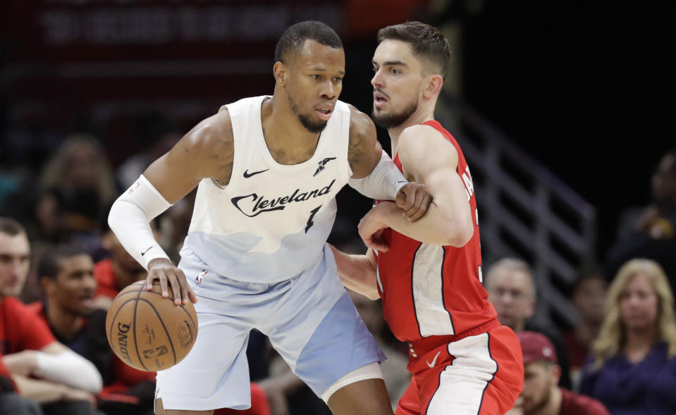 FILE- In this Jan. 29, 2019, file photo Cleveland Cavaliers' Rodney Hood, left, drives past Washington Wizards' Tomas Satoransky, from Czech Republic, in the second half of an NBA basketball game in Cleveland. The Cavaliers traded Hood to the Portland Trail Blazers. In exchange for Hood, Cleveland received guards Nik Stauskas and Wade Baldwin and a second-round pick in 2021 and 2023. The teams agreed to the deal on Sunday and completed their trade conference call with the NBA on Monday, Feb. 4. (AP Photo/Tony Dejak, File)