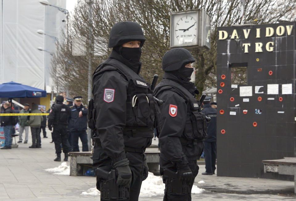 Bosnian Serb police secure an area at the spot where Davor Dragicevic along with members of the "Justice for David" movement protested and demanding the truth behind the death of 21-year-old David Dragicevic in the Bosnian town of Banja Luka, northwest of Sarajevo, Bosnia, Tuesday, Dec. 25, 2018. Bosnian Serb police have detained Davor Dragicevic, the man whose quest for the truth over the death of his son has sparked months of anti-government protests. (AP Photo/Radivoje Pavicic)