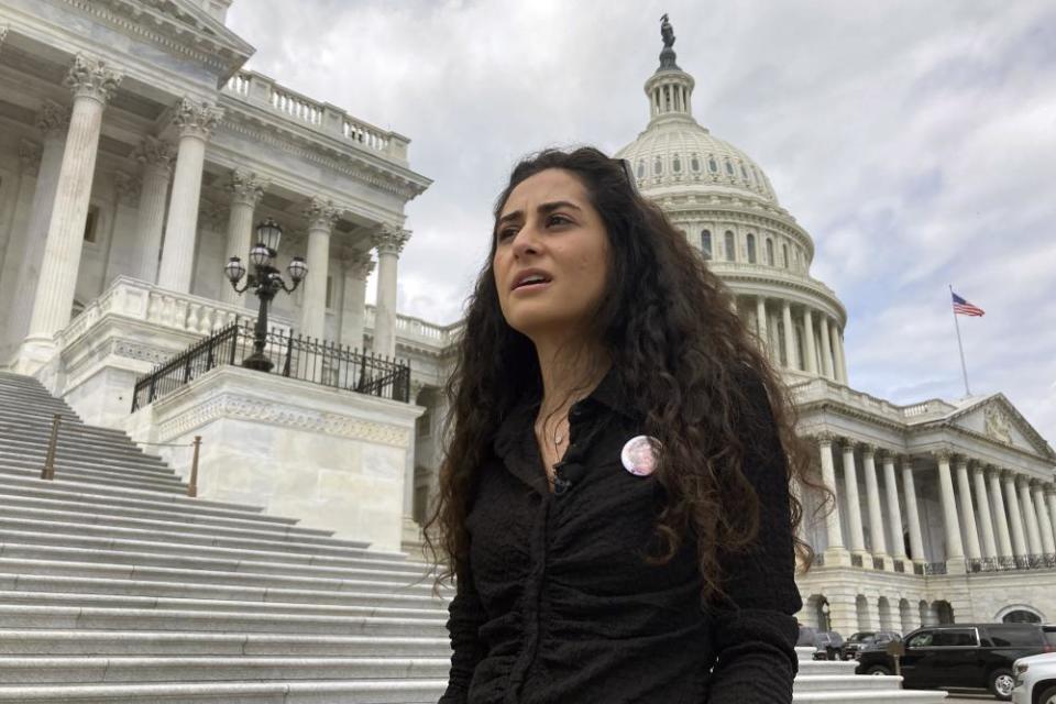 woman stands outside capitol