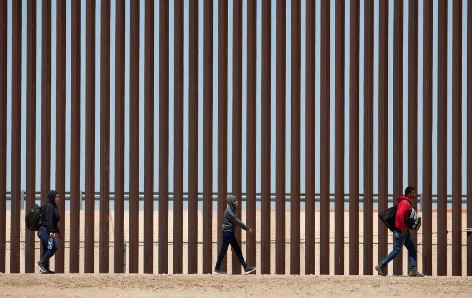 Migrants await to be processed at gate 40 of the border wall after having crossed the Rio Grande from Ciudad Juarez in hopes of turning themselves in with the intention of seeking asylum.