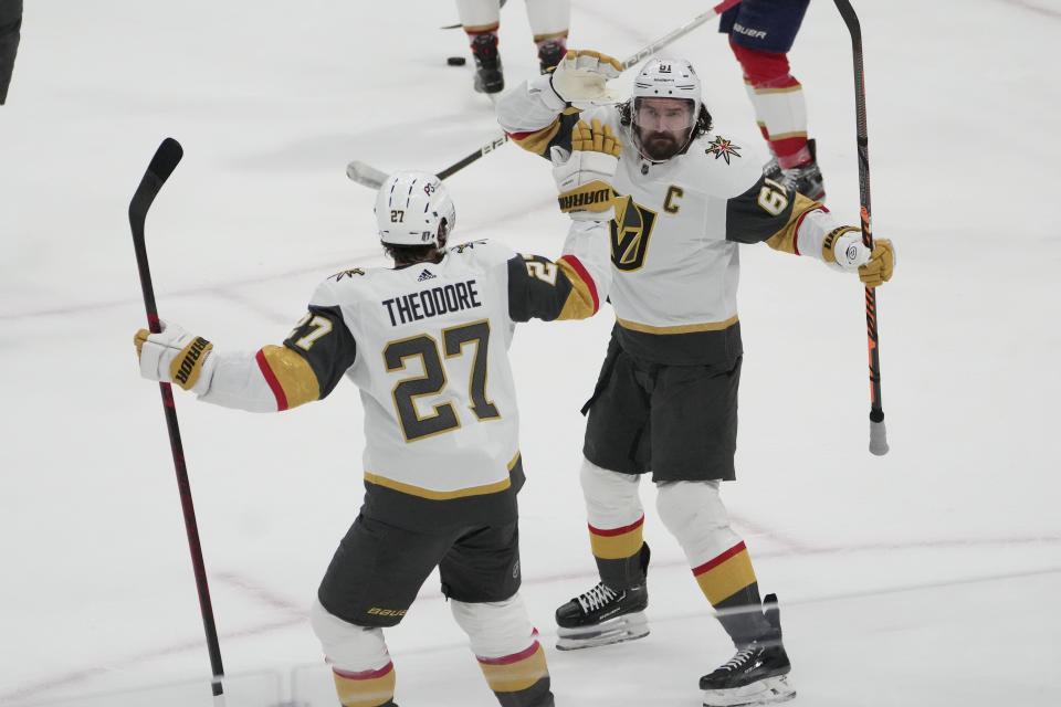 Vegas Golden Knights right wing Mark Stone (61) celebrates with defenseman Shea Theodore (27) after Stone scored a goal during the first period of Game 3 of the NHL hockey Stanley Cup Finals against the Florida Panthers, Thursday, June 8, 2023, in Sunrise, Fla. (AP Photo/Rebecca Blackwell)