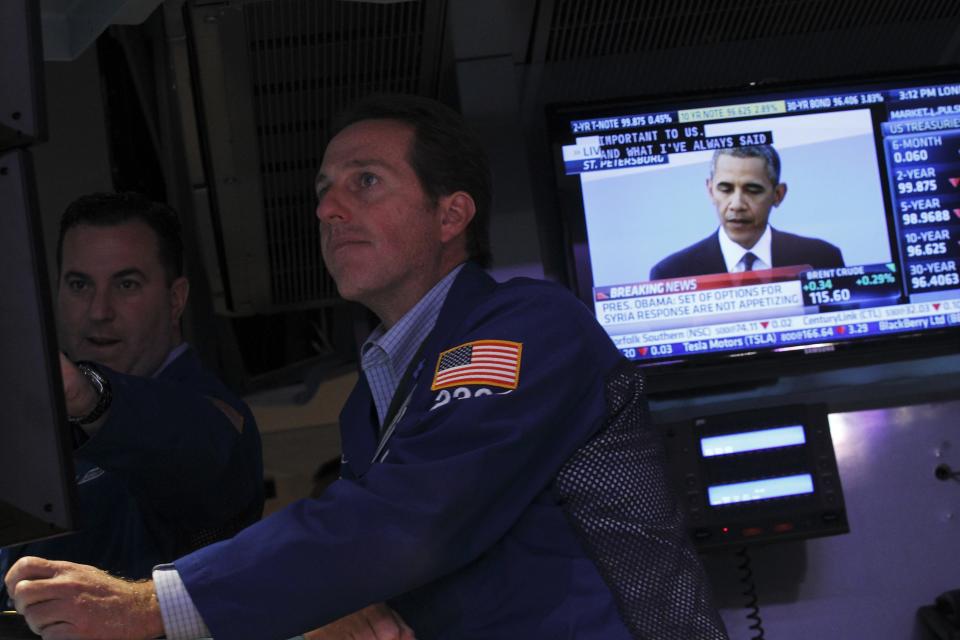 Traders work on the floor of the New York Stock Exchange as a television shows U.S. President Barack Obama’s news conference during the G20 summit in St. Petersburg, September 6, 2013. REUTERS/Brendan McDermid