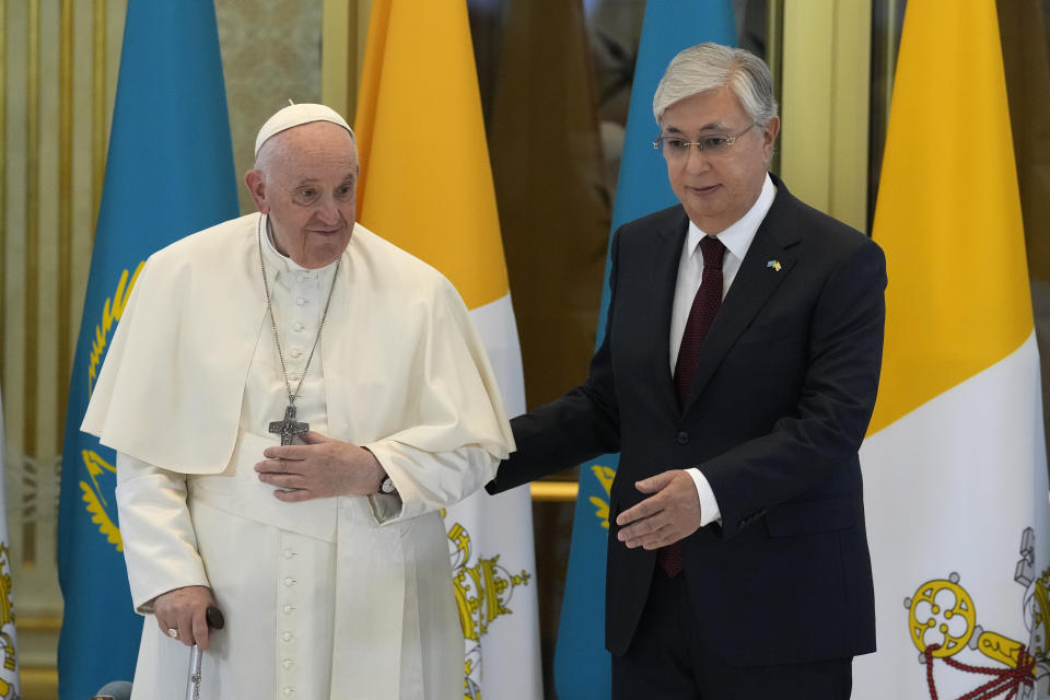 Pope Francis, left, meets the Kazakhstan's President Kassym-Jomart Tokayev as he arrives at Our-Sultan's International airport in Nur-Sultan, Kazakhstan, Tuesday, Sept. 13, 2022. Pope Francis begins a 3-days visit to the majority-Muslim former Soviet republic to minister to its tiny Catholic community and participate in a Kazakh-sponsored conference of world religious leaders. (AP Photo/Andrew Medichini)