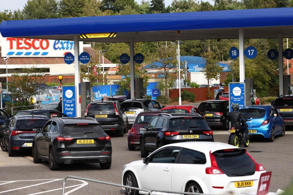 A line of vehicles queue to fill up at a Tesco petrol station in Camberley, west of London, on Sunday (AFP via Getty Images)