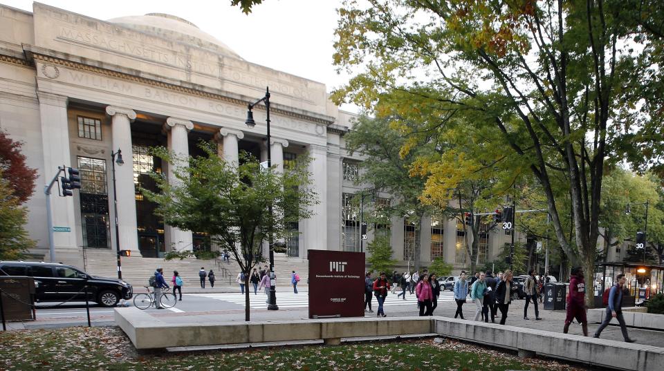 FILE - In this Oct. 21, 2015, file photo, students walk on the Massachusetts Institute of Technology campus in Cambridge, Mass. Disgraced financier Jeffrey Epstein donated more than $700,000 to the Massachusetts Institute of Technology and visited campus at least nine times after being convicted of sex crimes in 2008, according to new findings from a law firm hired to investigate Epstein's ties with the elite school, Friday, Jan. 10, 2020. MIT President L. Rafael Reif called the findings “a sharp reminder of human fallibility and its consequences.” ( AP Photo/Michael Dwyer, File)