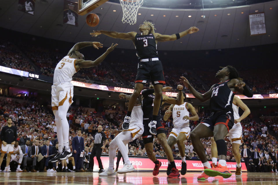 Texas guard Courtney Ramey, left, is blocked by Texas Tech guard Jahmi'us Ramsey (3) as he tries to score during the second half of an NCAA college basketball game, Saturday, Feb. 8, 2020, in Austin, Texas. Texas Tech won 62-57. (AP Photo/Eric Gay)