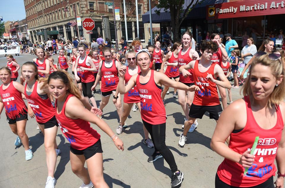 Bold dancers pass by during Ames' Fourth of July parade on Main Street Sunday, July 4, 2021, in Ames, Iowa.