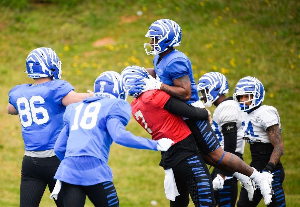 University of Memphis quarterback Grant Gunnell (7) picks up wide receiver Marcayll Jones (6), celebrating after Jones scores a touchdown during a game of scrimmage at Centennial high school in Franklin, Tenn., Saturday, April 2, 2022. 