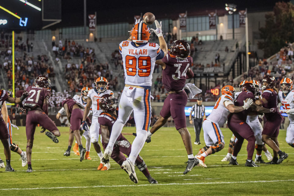 Syracuse's Dan Villari (89) catches a pass next to Virginia Tech's Alan Tisdale (34) during the second half of an NCAA college football game Thursday, Oct. 26, 2023, in Blacksburg, Va. (AP Photo/Robert Simmons)