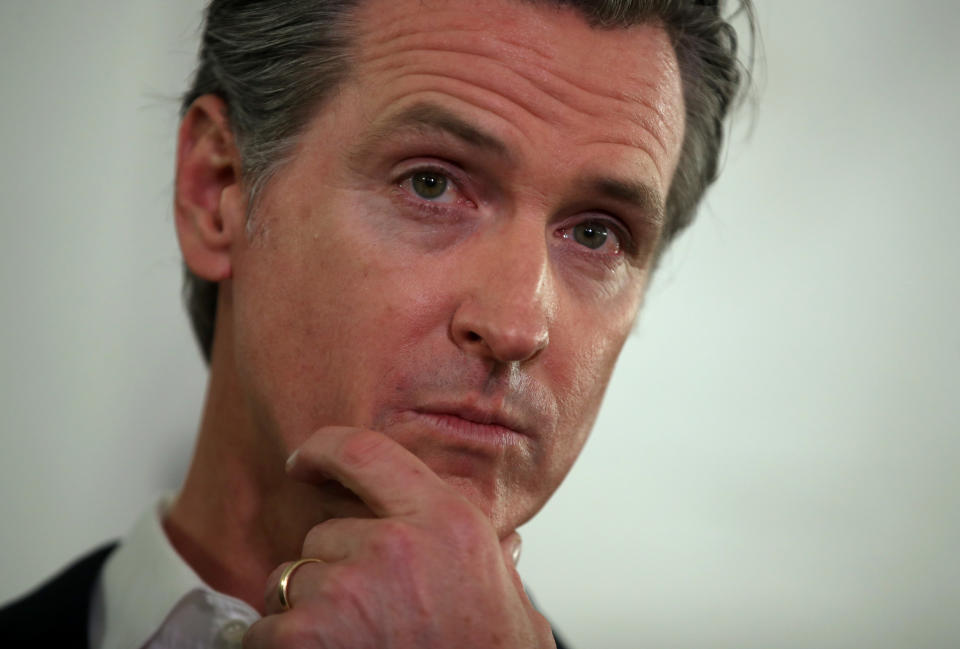 OAKLAND, CALIFORNIA - JANUARY 16: California Gov. Gavin Newsom looks on during a a news conference about the state's efforts on the homelessness crisis on January 16, 2020 in Oakland, California. Newsom was joined by Oakland Mayor Libby Schaaf to announce that Oakland will receive 15 unused FEMA trailers for the city to use as temporary housing and as mobile health and social services clinics for the homeless. Newsom signed on executive order on January 8 to deploy 100 trailers and crisis response teams to areas in need across the state.  (Photo by Justin Sullivan/Getty Images)