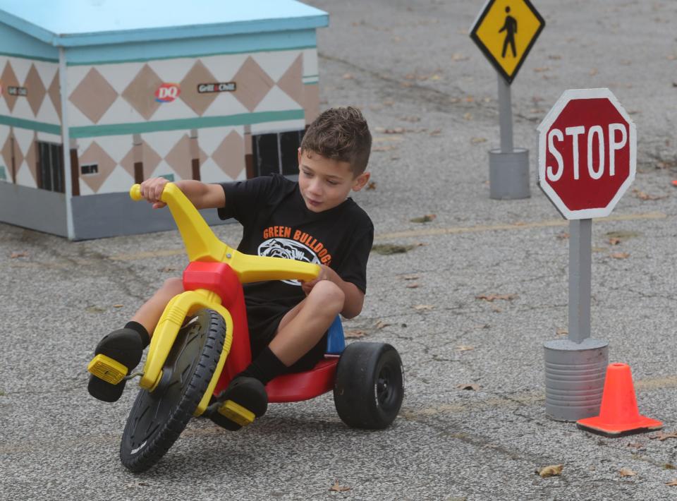 Giovanni Rimedio, 7, of Green, rides around safety town during the Faith & Blue event on Saturday at Hardesty Park.