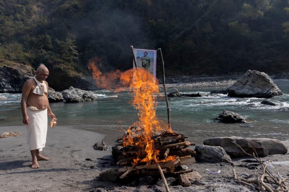 Gangadahr Prasad Aryal, an uncle of the deceased Hari Aryal, cremates a symbolic representation of Hari’s body at the bank of the Kaligandaki River (EPA)