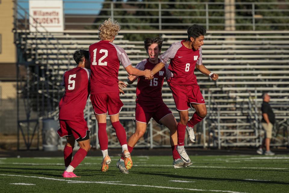 Willamette players celebrate a goal by teammate Joaquin Balcazar-Recinos, right, as the Willamette Wolverines defeat Sheldon 3-2 Wednesday.