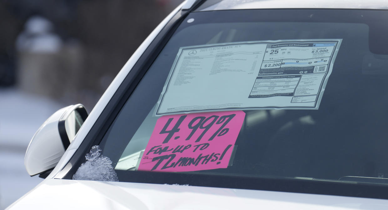 A sign highlighting the interest rate hangs under the sticker on an unsold 2023 model on display outside a Mercedes-Benz dealership on Thursday, Nov. 30, 2023, in Loveland, Colo. (AP Photo/David Zalubowski)