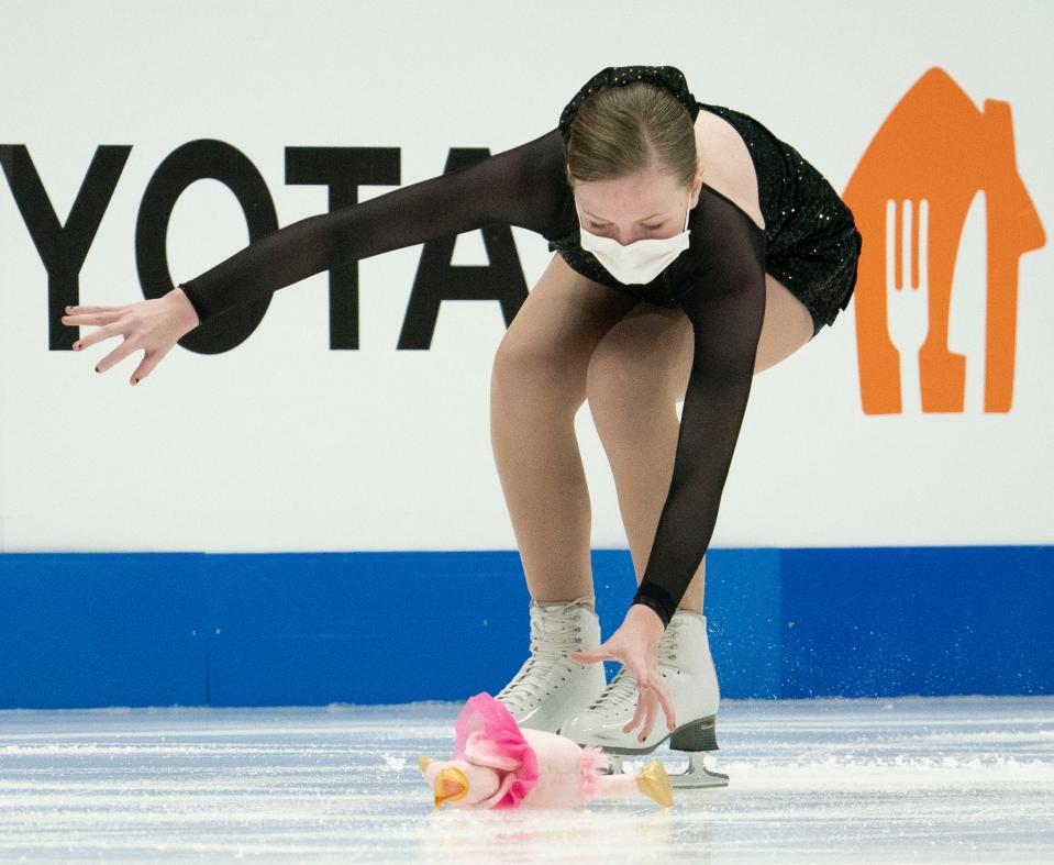 A sweeper collects a doll thrown on the ice for a competitor during the Junior Men Free Skate Competition in the 2022 Toyota U.S. Figure Skating Championships at Bridgestone Arena Wednesday, Jan. 5, 2022 in Nashville, Tenn.