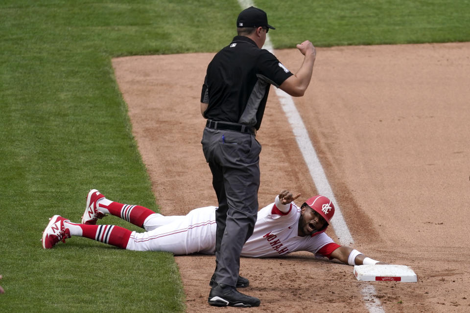 Kansas City Royals' Kelvin Gutierrez appeals to third base umpire Lance Barrett after being tagged out trying to advance to third on a sacrifice double play hit into by Hanser Alberto during the seventh inning of a baseball game against the Detroit Tigers Sunday, May 23, 2021, in Kansas City, Mo. Andrew Benintendi scored on the play. (AP Photo/Charlie Riedel)