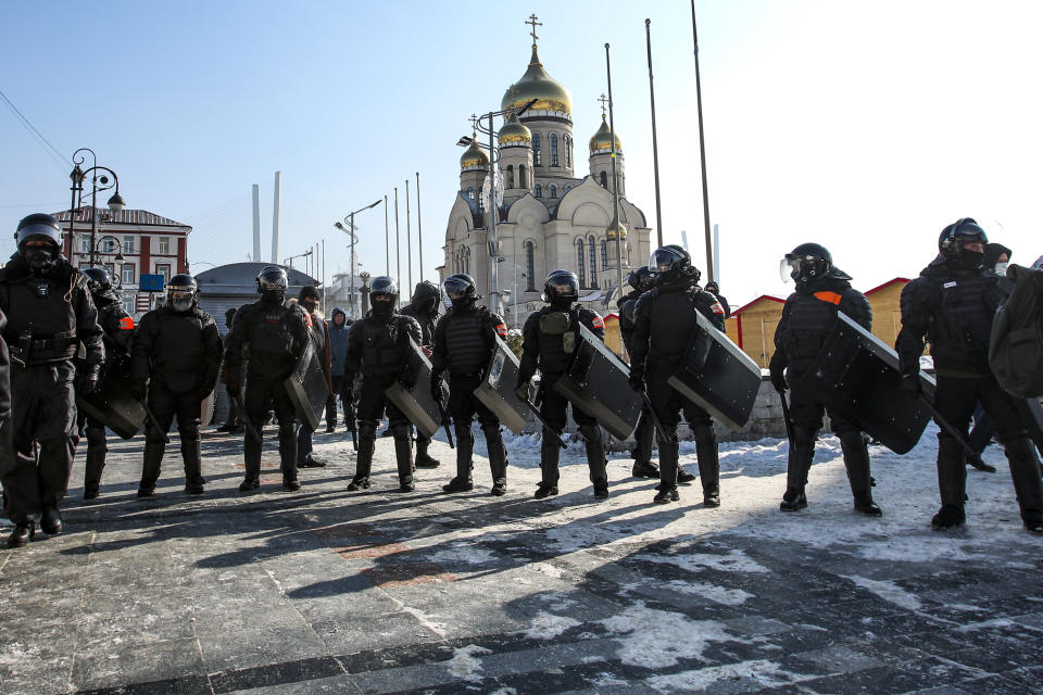 Police officers stand blocking enter to the central square in Vladivostok, Russia, on Sunday, Jan. 31, 2021. As part of a multipronged effort by the authorities to discourage Russians from attending Sunday's demonstrations, the Prosecutor General's office ordered the state communications watchdog, Roskomnadzor, to block the calls for joining the protests on the internet. (AP Photo/Aleksander Khitrov)