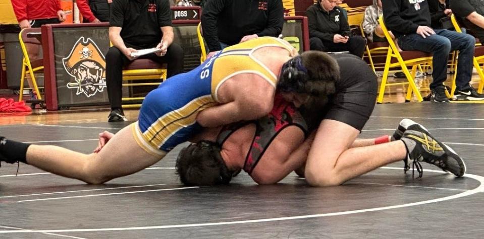 Jefferson's Anthony Cousino battles Tasen Bevins of Milan in the Huron League Tournament Saturday. Cousino won the 165-pound weight class and Jefferson won the tournament.