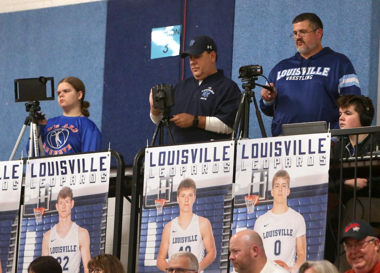 Michaela Blaho, from left, a videographer from Western Reserve; Rob Johnson, center, a videographer from Louisville; and Bob Burick, right, who was providing live streaming for Louisville, had an upper-level view of Western Reserve's Dec. 6, 2021, girls basketball game at Louisville.