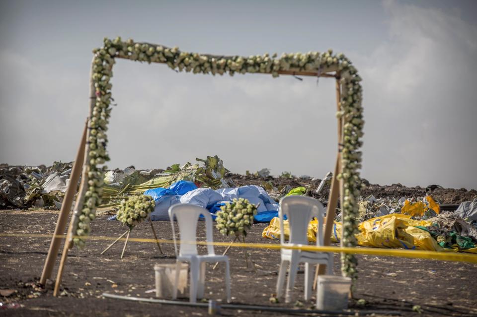 Wreaths and floral installations stand next to piles of wreckage at the scene where the Ethiopian Airlines Boeing 737 Max 8 crashed shortly after takeoff on Sunday killing all 157 on board, near Bishoftu, or Debre Zeit, south of Addis Ababa, in Ethiopia on March 13, 2019.