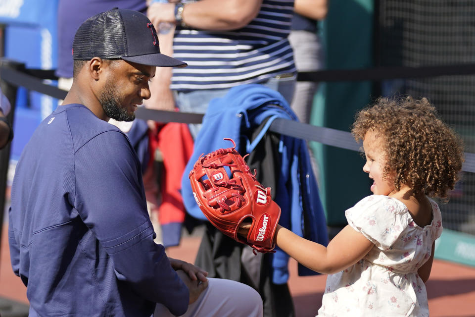 Boston Red Sox's Pablo Reyes, left, play with his daughter Maisy, right during batting practice before a baseball game against the Cleveland Guardians, Wednesday, June 7, 2023, in Cleveland. (AP Photo/Sue Ogrocki)