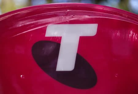 FILE PHOTO: A Telstra logo adorns a phone booth in the central business district (CBD) of Sydney in Australia, February 13, 2018. REUTERS/David Gray