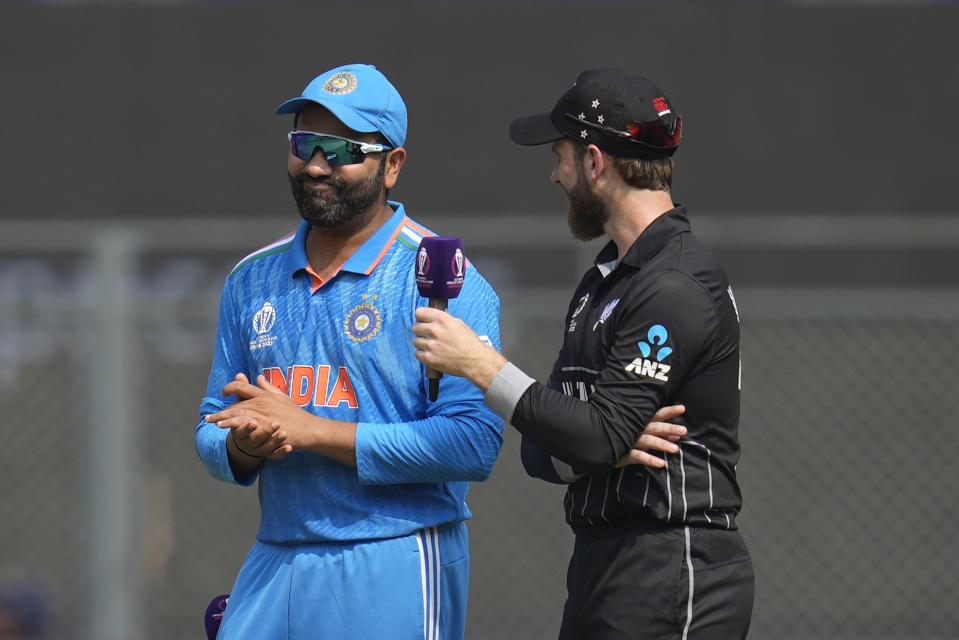 India's captain Rohit Sharma and New Zealand's captain Kane Williamson talk at the coin toss during the ICC Men's Cricket World Cup first semifinal match between India and New Zealand in Mumbai, India, Wednesday, Nov. 15, 2023. (AP Photo/Rafiq Maqbool)