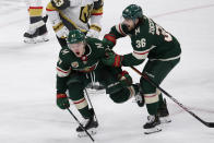 Minnesota Wild left wing Kirill Kaprizov (97) celebrates his goal with right wing Mats Zuccarello (36) during the third period against the Vegas Golden Knights in an NHL hockey game Wednesday, May 5, 2021, in St. Paul, Minn. The Golden Knights won 3-2 in overtime. (AP Photo/Andy Clayton-King)