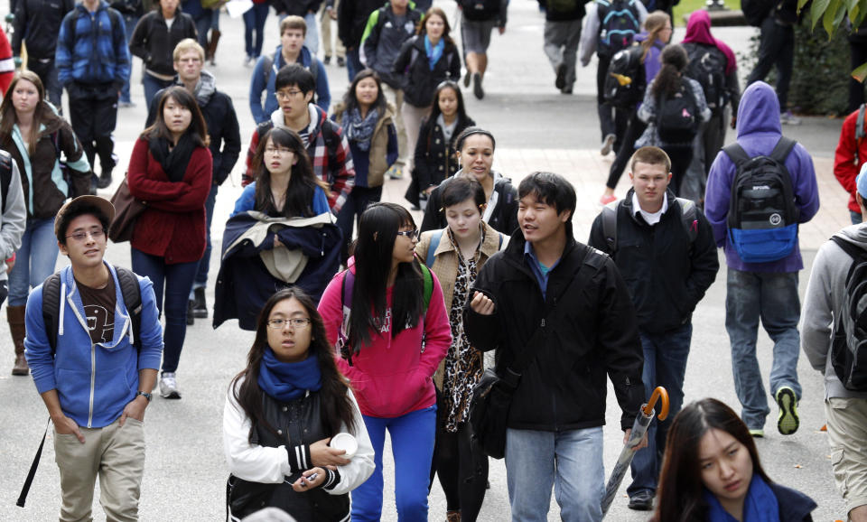 University of Washington students walk on the campus between classes Tuesday, Oct. 23, 2012, in Seattle. The university has about a thousand more international students on the campus this fall, but university officials say that doesn't mean they have cut back on the number of in-state students at the state's most selective public university. (AP Photo/Elaine Thompson)