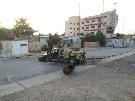 An abandoned Iraqi security forces vehicle is pictured on a road in Tikrit, which was overran by the Islamic State in Iraq and the Levant (ISIL), June 11, 2014. REUTERS/Stringer