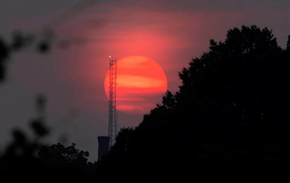 The sun sets looking west from the Boylan Avenue bridge in Raleigh, N.C. Tuesday, June 6, 2023. More than 400 Canadian wildfires continue to scorch land near Quebec, sending clouds of smoke downwind to the United States, including the Carolinas. 