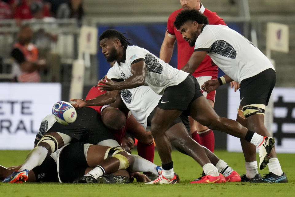 Fiji's Frank Lomani passes the ball during the Rugby World Cup Pool C match between Wales and Fiji at the Stade de Bordeaux in Bordeaux, France, Sunday, Sept. 10, 2023. (AP Photo/Themba Hadebe)